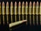 Metal cartridges for hunting automatic weapons on a black background with a reflection