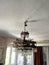 Metal carved chandelier with crystal pendants on the ceiling