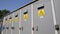 Metal cases with high voltage caution signs at substation