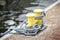 Metal chains with yellow bollards. Part of yacht anchor. Detail of sailboat. Transportation