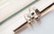 metal chopstick insert within two diamond wedding rings for groom and bride on white background