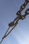 A metal clip connects the steel rope. The blue sky is in the background