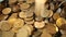 Metal coins falling into a pile, close-up