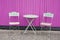 Metal colorful chair seat table in summer in street front pink wooden wall