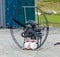 A metal contraption with a gas engine being used for paragliding