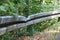 Metal crash barriers or guard rails damaged due to a collision with a vehicle.