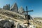 Metal cross and the background of the Tre Cime. Tre Cime di Lavaredo with beautiful blue sky,