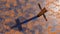 Metal cross on a rusted corroded metal or steel sheet background. 3d illustration metaphor for God, Christ