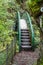 Metal curved footbridge with steps