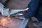 Metal cutting, steel with acetylene torch in factory. wear protective gloves when working with fire flakes
