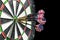Metal darts have hit the red bullseye on a dart board. Darts Game. Darts arrow in the target center darts in bull`s eye close up.