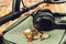 Metal detector and bunch of coins on wooden board