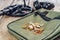 Metal detector and bunch of coins on wooden board