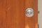 Metal door knob on wooden opened door. Soft focus