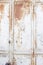 Metal door with rust, crack and old loose white paint texture