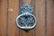 Metal doorknocker at wooden door