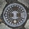 Metal drain lid or manhole cover abstract metallic circle