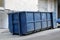 Metal durable blue industrial trash bin for outdoor trash at construction site. Large waste basket for household or industrial