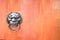 metal evil face pull door and hard wood surface background