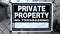 Metal Fence with Black and White Private Property No Trespassing Warning Sign Close Up