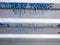 Metal fence with blue paint. close-up. Ribbed gray. Place for an inscription. background for the project. Corrugated metal fence.