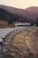 Metal fence on a mountain road landscape edge