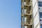 Metal fire escape stairs construction outdoor side of high building and empty blue sky, copy space