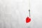 A metal fishing hook hanging on a rope pierced the Red cardboard heart. concept of love