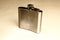 Metal flask on a gray background