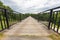 Metal footbridge over the river. Pedestrian crossing over a gorge in Central Europe