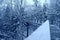 Metal footbridge over the stream, in winter snowy forest, beautiful winter landscape