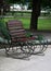 Metal forged bench in summer park