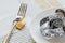 Metal fork locked with padlock and white plate with measuring tape on a tablecloth. Control the amount of food eaten