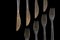 Metal forks and knives on a black background. top view on stainless knives and forks with copy space