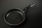 Metal frying pan: Ceramic coating with non-stick coating: Kitchen utensils On a black background: Cooking for chefs in the