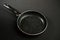 Metal frying pan: Ceramic coating with non-stick coating: Kitchen utensils On a black background: Cooking for chefs in the