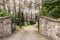 Metal gate open to a cobblestone driveway to a luxurious summer