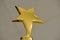 Metal golden star in blurred grey background