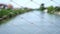 Metal grid fence against blurred view of river with bokeh