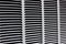 Metal grille for gray ventilation. Industrial background. Black horizontal and diagonal stripes on a gray background