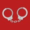 Metal handcuffs for detaining criminals on red background. Outfit of a policeman. Element of police and prison icon of