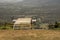 Metal hang gliding ramp overlooking a valley.