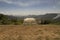 Metal hang gliding ramp overlooking a valley.