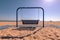 Metal hanging bench swing on a beach in Grand Haven State Par