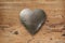 Metal heart on wood