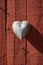 Metal heart on a wooden substrate. Painted wooden boards. A heart made of metal as a symbol of love
