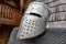 Metal helmet for a knight on a hanger. Accessories for soldiers in the Middle Ages