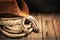 Metal horseshoe and cowboy hat on wooden table