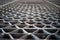 Metal industry steel grade sheet or floor grating with multicolored drops of paint macro closeup. Shallow depth of field