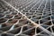 Metal industry steel grade sheet or floor grating with multicolored drops of paint macro closeup. Shallow depth of field